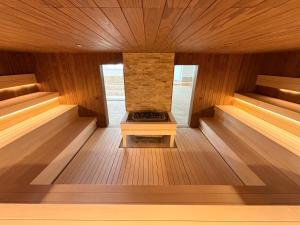 an empty sauna with a fireplace in the middle at Zenit Wellness Hotel Balaton in Vonyarcvashegy +77 photos