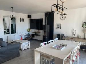 a living room with a table and a couch at maison de famille ile de ré 3 étoiles in Sainte-Marie-de-Ré