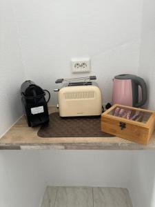 a counter with a toaster and a toaster and a coffee maker at Fedra Apartments Lindos in Líndos