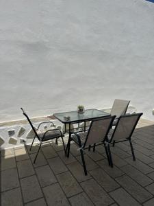 a table and chairs sitting on a patio next to the ocean at Fedra Apartments Lindos in Líndos