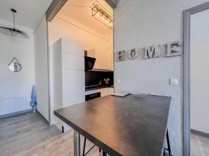 a dining room with a table in a room at Cannes City Break - 2nd Floor - Sunny Balcony & Quiet Street in Cannes
