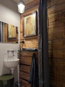 a bathroom with a toilet and a sink and a mirror at TACIS design apartment in Salacgrīva