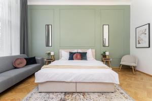 a bedroom with a large bed and a couch at Fancy Home Prague #2 in Prague +30 photos