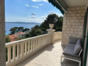 a balcony with a chair and a view of the water at Apartment Esperansa in Brela