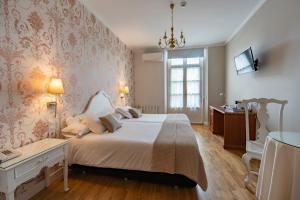a bedroom with a large bed and a window at Hotel Infanta Isabel by Recordis Hotels in Segovia