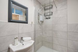 リバプールにあるWoolton Rd Flat Near John Lennon Airport, Free Parking & Wifi - Pass the Keysの洗面台とシャワー付きの白いバスルーム