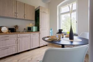 a kitchen with a table with a vase on it at Boarding & Monteur Apartment CMTZ in Chemnitz