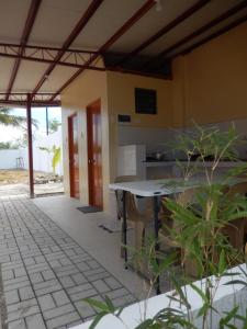 a kitchen and dining area of a house with a table at Sunset Garden Lambug Badian in Badian