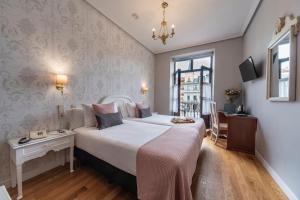 a hotel room with a large bed and a window at Hotel Infanta Isabel by Recordis Hotels in Segovia