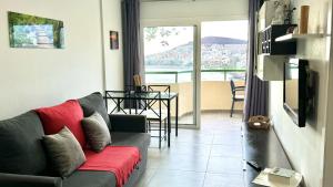 a living room with a couch and a table at Costamar Infinite Sea Views by Deihu Experiences in Los Cristianos