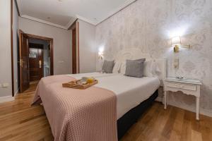 a hotel room with a bed with a tray on it at Hotel Infanta Isabel by Recordis Hotels in Segovia