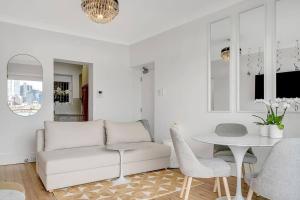 a living room with a white couch and a table at Kirribilli Kanangra in Sydney