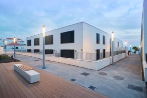 a white building with a bench in front of it at Sol de Abades Live Canarias in Abades