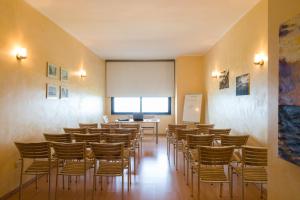 a room with a bunch of chairs and a podium at Hotel Villa Mare in Altavilla Milicia