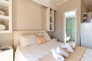 a bedroom with a white bed with two pillows at SkyBlue Horizon Studio 3 in Tsilivi