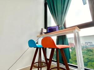 a table and two chairs in front of a window at Cozy Place 1-8 Pax 3 bedroom Ara Damansara in Petaling Jaya