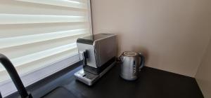 a desk with a computer monitor and a blender at Apartmán Rychvald in Rychwald