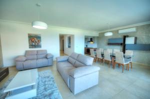 a living room with a couch and a table at Fort Cambridge Apartments in Sliema