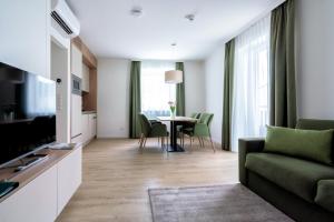 a living room with a couch and a table at Landhaus Bad Gleichenberg in Bad Gleichenberg