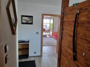 a hallway with a wooden door leading into a house at Privatunterkunft Straubing in Straubing