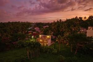 a house in the middle of a forest at night at Rai Villa Colombo in Colombo