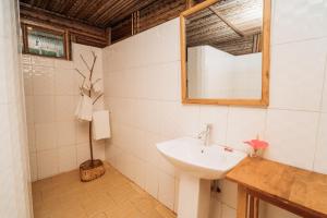 a bathroom with a sink and a mirror at Maisara Mafia Beach Lodge in Kilindoni