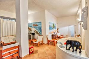 a toy elephant on a shelf in a room at HOTEL Al FARO , SPIAGGIA LA CINTA ,SAN TEODORO in San Teodoro