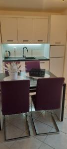 a kitchen with a table with two chairs and a sink at Apartment near the center - Nada in Malinska