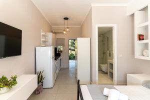a kitchen with two white refrigerators and a dining room at SkyBlue Horizon Studio 2 in Tsilivi