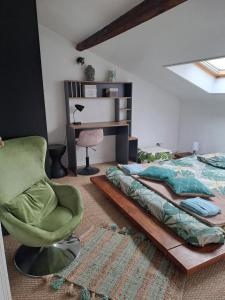 a bedroom with a bed and a chair and a desk at Atypique Saumur 80 m2 joli appartement 2 à 7 pers familial rénové entier 3 chambres hyper centre in Saumur