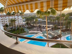 a view of a resort with palm trees and pools at Paraíso Maspalomas Experience in San Bartolomé