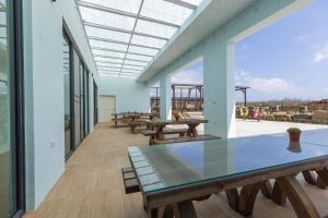 a patio with benches and a glass table at Tinghai Leisure homestay in Magong