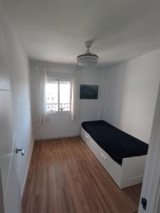 a bedroom with a bed in a room with a window at Apartamento Fuengirola Costa in Fuengirola +36 photos