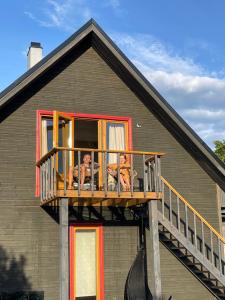 two people sitting on a balcony of a house at Muhusi rooftop getaway in Igaküla
