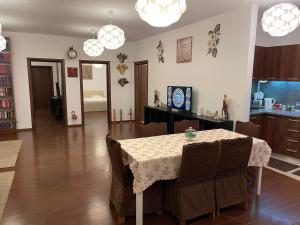 a kitchen and dining room with a table and chairs at A.U.M House in Bucharest