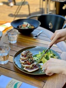 a plate of food on a table with a plate of food at Domaine Les Lanternes in Saint-Cyr-au-Mont-dʼOr