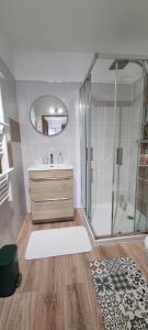 a bathroom with a shower and a sink and a mirror at Chambre St-Loup in Saint-Mathieu-de-Tréviers