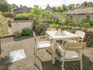 a white table and chairs on a patio at The Cottage Bradwell in Bradwell