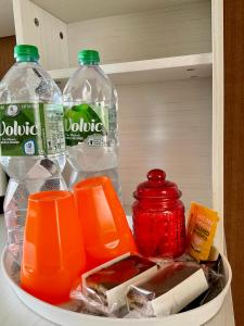 einen Kühlschrank mit 2 Flaschen Wasser und anderen Artikeln in der Unterkunft Private double room near Metro 5 Bobigny in Bobigny
