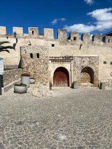 a large stone building with a large wooden door at Bab El Fen in Tangier