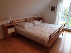 um quarto com uma cama com uma cabeceira de madeira em Huus 24 em Borkum