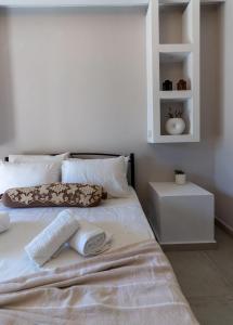 a white bed with two towels on top of it at SkyBlue Horizon Studio 1 in Tsilivi