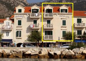 a large building with balconies on the side of the water at Bol Story in Bol