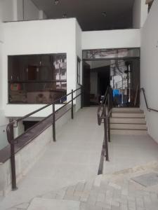 a hallway of a building with stairs and a window at Ágape Hotel De Aparecida in Aparecida
