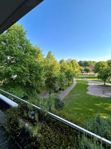a view of a park from a balcony at Residenz am Pferdemarkt - exklusives Wohnen im Herzen Ostfrieslands - stillvoll & luxuriös in Aurich