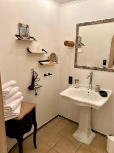 a bathroom with a sink and a mirror at Residenz am Pferdemarkt - exklusives Wohnen im Herzen Ostfrieslands - stillvoll & luxuriös in Aurich +14 photos
