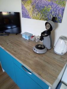 a desk with a coffee maker and a blender on it at Room by the sea in Zoutelande