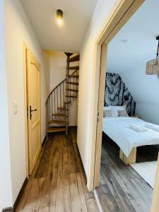 a small room with a bed and a staircase at Luxury Houses & Apartments Zaliński in Zakopane