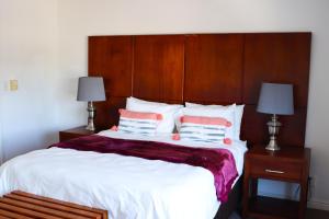a bedroom with a large bed with two pillows at Waterfront Delight in Knysna +31 photos