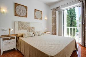 a bedroom with a large bed and a large window at Apartamentos Ducal Center de playa gandia in Playa de Gandia